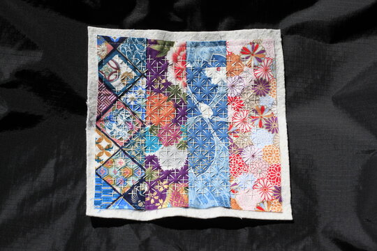 Hand-stitched Sashiko patchwork square featuring traditional geometric and floral patterns on Japanese cotton fabrics 