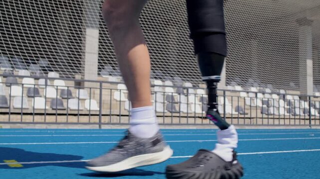Young man racer uses bionic prosthesis instead of leg on track