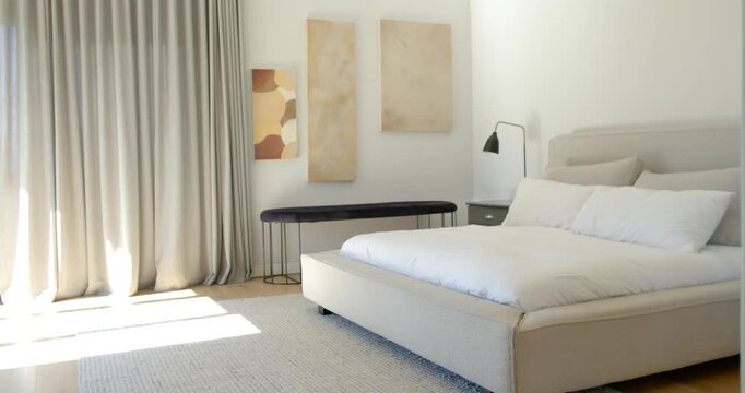 Camera panning right, revealing bedside table while bed remaining centered and sunlight narrowing