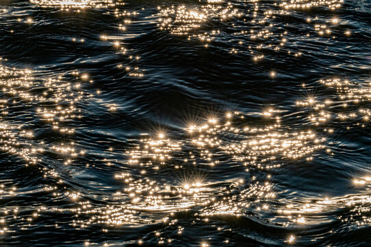 Sunlight reflected in rippled water surface