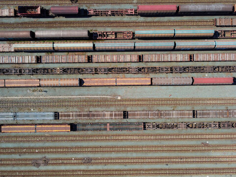 Aerial view of the Orbassano interporto ferroviario with multiple parallel tracks and freight wagons at the railway terminal in Orbassano, Piedmont, Italy.