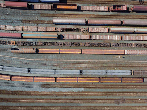 Aerial view of freight trains and cargo wagons on multiple tracks at the Orbassano interporto ferroviario rail terminal in Orbassano, Piedmont, Italy.