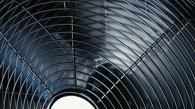 Close-Up of Electric Cooling Fan on Grille and Rotating Blades