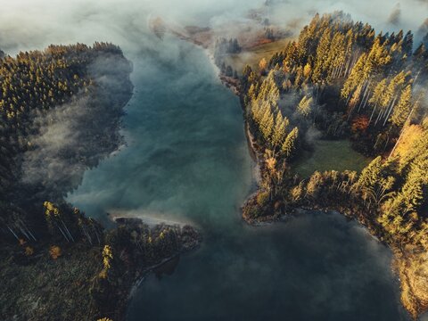 Autumn sunrise in the foothills of the Alps with fog at Illasbergsee and Forggensee near Halblech in Allg&auml;u, Bavaria, Germany