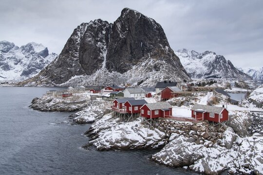 Winter landscape with colourful Scandinavian boathouses, Hamn&oslash;y, Nordland, Lofoten, Norway