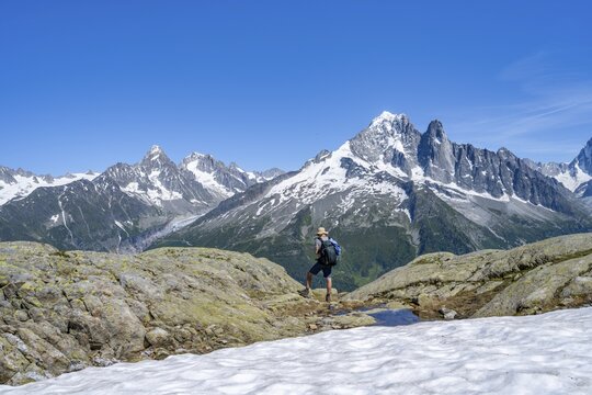Mountaineer on a hiking trail in front of a mountain landscape, view of mountain peak Aiguille Verte of the Mont Blanc massif, Aiguilles Rouges, Chamonix-Mont-Blanc, Haute-Savoie, France