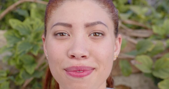 African American woman starting neutral, smiling then laughing by vine wall with gold studs