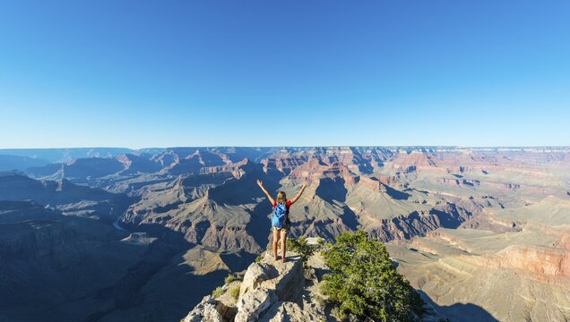 Tourist, hiker looking into Grand Canyon, South Rim, Grand Canyon National Park, Arizona, USA