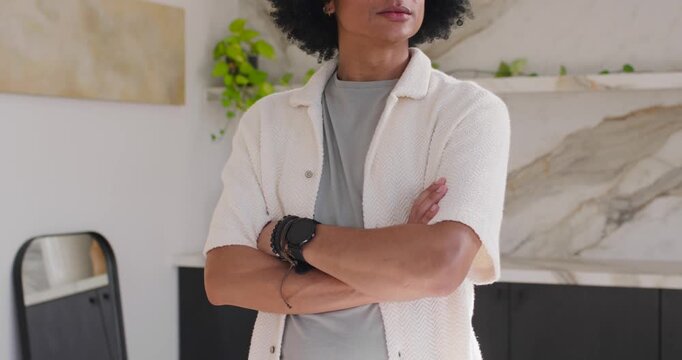 African American man posing armscrossed near backsplash, camera pulling back urging gaze in kitchen