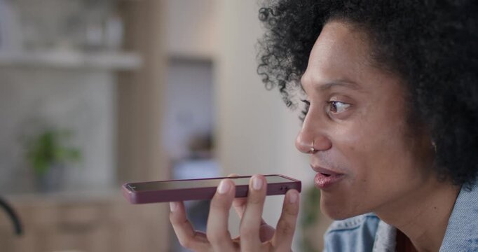 African American man lifting phone, filming, smiling, laughing in kitchen, denim shirt, copy space