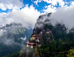 Fototapeta premium Misty Mountain Monastery Perched on Rocky Cliff in Lush Himalayan Valley