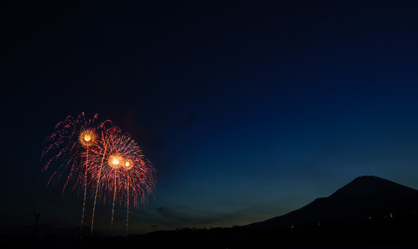 fireworks in the night sky with Fuji mountain background