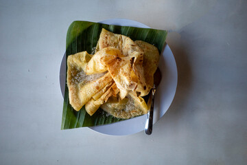 Roti Canai, Cane Cake served on green banana leaves, sprinkled with granulated sugar © JakaSuryanta