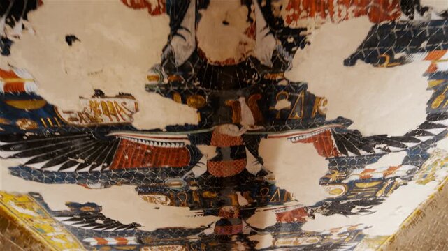 Close-up of ancient Egyptian relief carving inside KV17 tomb of Seti I, Valley of the Kings, Luxor, Egypt, showing a deity figure with black hair and deteriorating pigment.