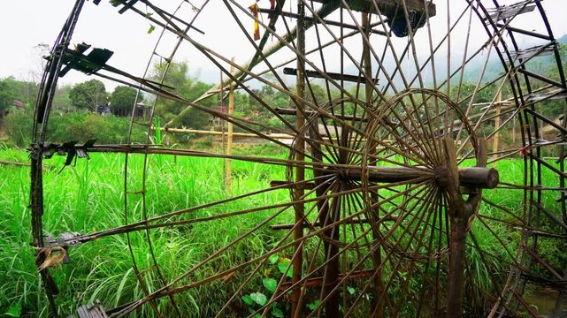 Traditional Wooden Water Wheel in Vietnam Rice Fields Ancient Hydraulic Irrigation System for Sustainable Agriculture and Rural Farming Landscape