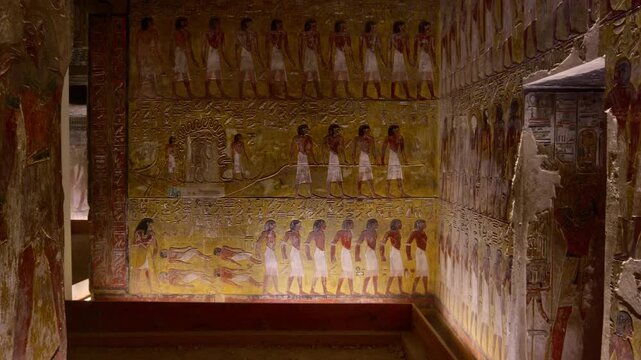 Close-up of ancient Egyptian relief carving inside KV17 tomb of Seti I, Valley of the Kings, Luxor, Egypt, showing a deity figure with black hair and deteriorating pigment.