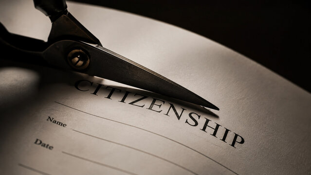 Scissors cutting document to revoke citizenship status