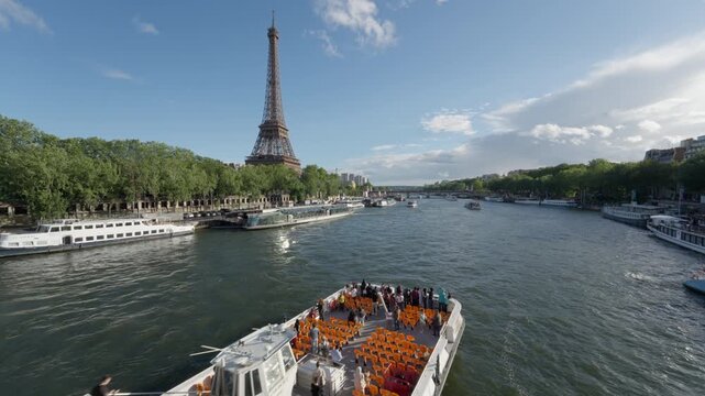 Tourists on a large white cruise ship sail along the Seine River near the Eiffel Tower in Paris France. Sightseeing excursion ferry boat, European group vacation trip, summer river voyage.