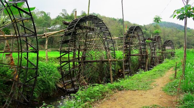 Traditional Wooden Water Wheel in Vietnam Rice Fields Ancient Hydraulic Irrigation System for Sustainable Agriculture and Rural Farming Landscape