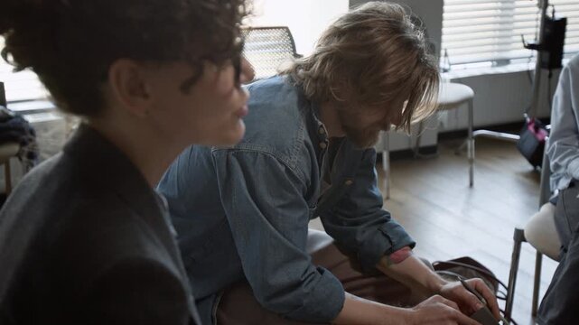 Man sharing struggles and running hand through hair during group therapy session with female psychotherapist. Perfect for mental health campaigns or counseling services