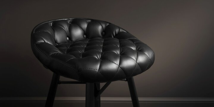 Stylish bar stool with black leather and intricate diamond upholstery showcasing expert design