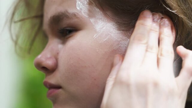 Applying protective cream to face before hair coloring