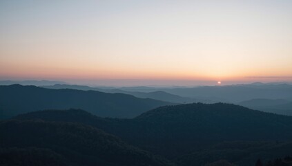 Fototapeta premium Sunrise over rolling mountains in the distance