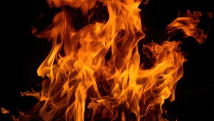 Fototapeta premium Flames rising against a dark background