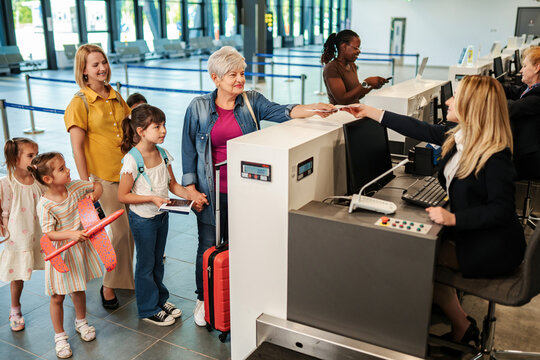 Multi-generational family checking in at airport for vacation