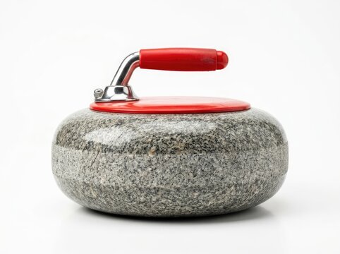 A curling stone with a red handle sits on a white surface