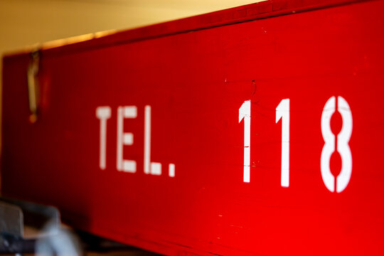 Swiss Fire Emergency Number 118 on Fire Brigade Equipment Close Up, Close-up photograph of the Swiss fire emergency number 118 displayed on red fire brigade equipment. Selective focus, authentic firef