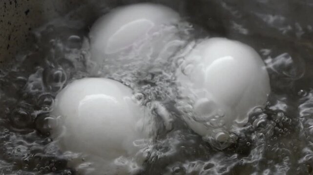 Boiling eggs in a pot of water on the stove
