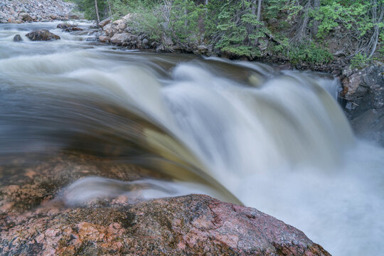 Cache la Poudre River at Poudre Falls in northern Colorado, early summer scenery with a high flow