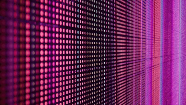 Close up texture of LED video wall pixels creating a bright colorful backdrop with copy space