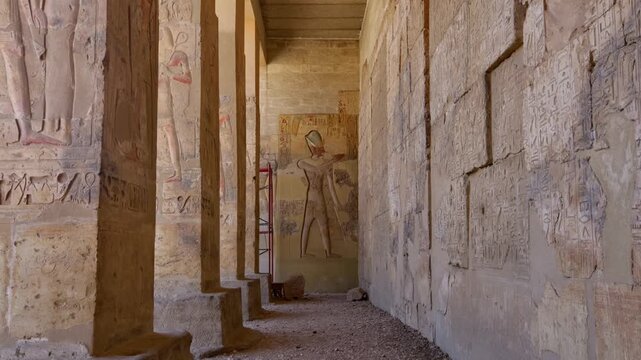 Ancient hall of the Abydos Temple with towering columns and intricate hieroglyphs, showcasing the spiritual depth and architectural mastery of Ancient Egypt.