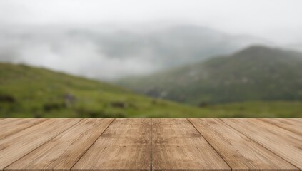 Obraz premium Smooth wooden table with natural copy space framed by a dreamy blurred mountain and lush grass scene