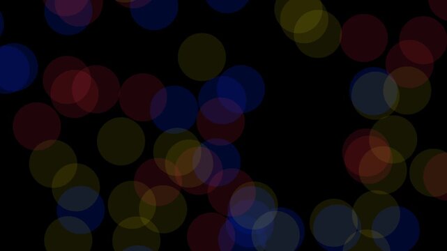 Red, yellow, and blue translucent bokeh circles pulsing and fading on a black background.