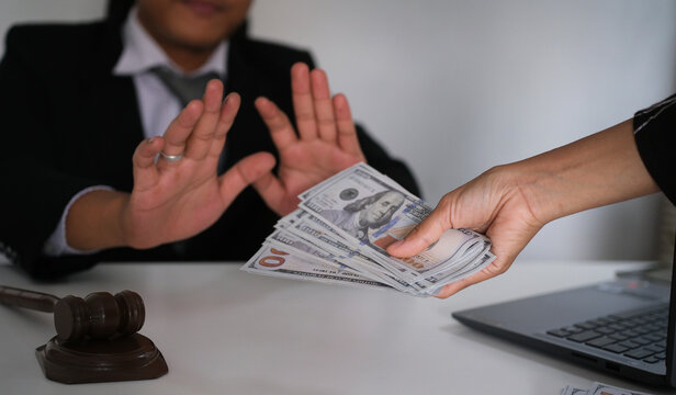 A lawyer refusing a bribe by rejecting cash offered by a client, symbolizing integrity, honesty, and ethical responsibility in the legal profession and justice system
