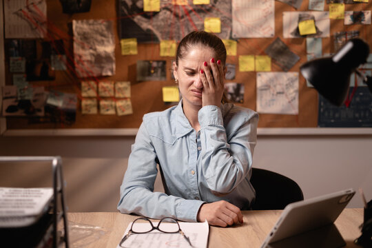 sad woman detective put hand on face facepalm epic fail mistaken omg gesture working late night with evidence