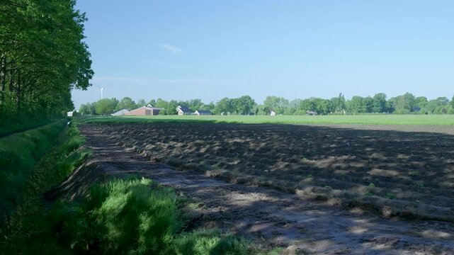 Rural landscape with plowed field and irrigation ditch