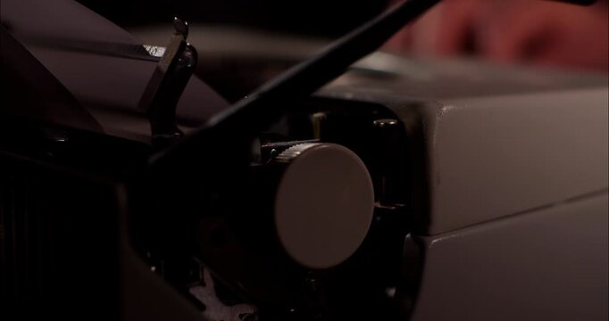 Close up of a vintage typewriter in a dark indoors setting