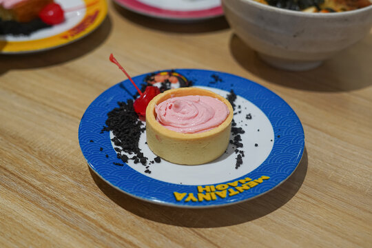Delicious pink cream tartlet dessert served with cherry. May 1, 2025, in Sukoharjo, Indonesia