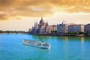 Hungarian Parliament Building at sunset with cruise ship on the Danube river, Budapest, Hungary © AlexAnton