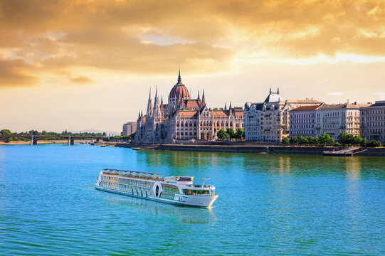 Hungarian Parliament Building at sunset with cruise ship on the Danube river, Budapest, Hungary