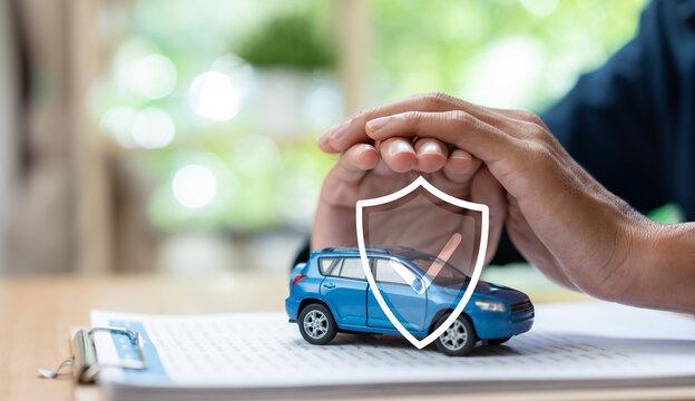 Car insurance protection concept featuring vehicle model under protective hands and shield icon, representing auto coverage, risk management, financial security, policy protection, and safe ownership.
