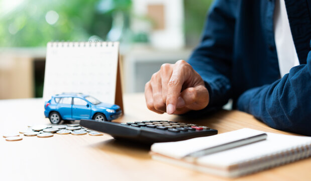 Car loan payment and auto financing concept with vehicle model, calculator, coins, and calendar, representing budgeting, installment planning, vehicle ownership costs, and financial management.