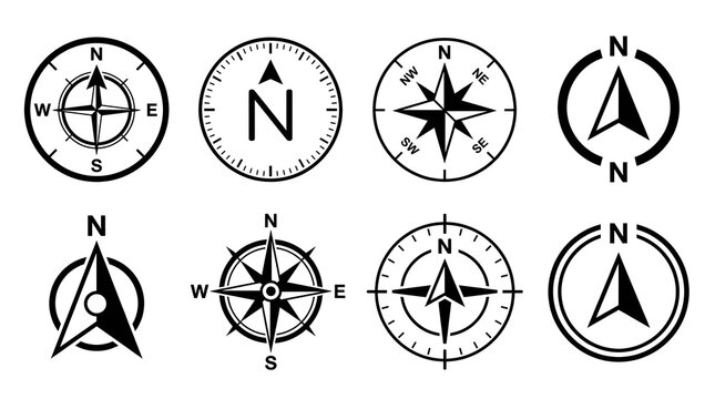 Set of Compass and Navigation Symbols: A collection of eight distinct compass rose and north arrow icons, presented in a clean, graphic style, symbolizing direction, guidance, and exploration.