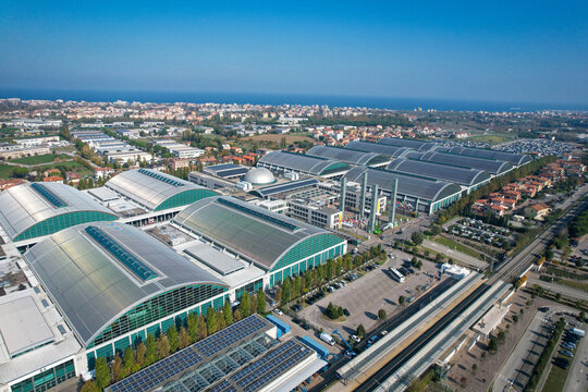 Aerial view of the Fiera di Rimini exhibition center featuring modern pavilions with curved green roofs and solar panels in Rimini, Emilia-Romagna, Italy.