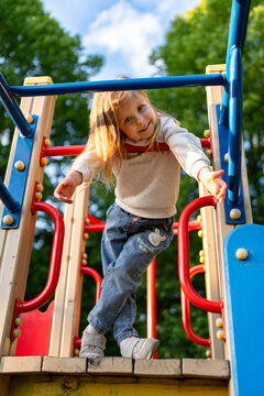Cute beautiful smiling little girl on the playground for fun, games or recreation. Face and happy with adorable kid outdoor for development, growth or recess in summer.