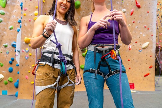 top rope climbing partners friends inside gym 